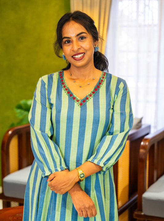 Striped cotton dress showing red and green floral embroidery at the neckline - Ariyaa