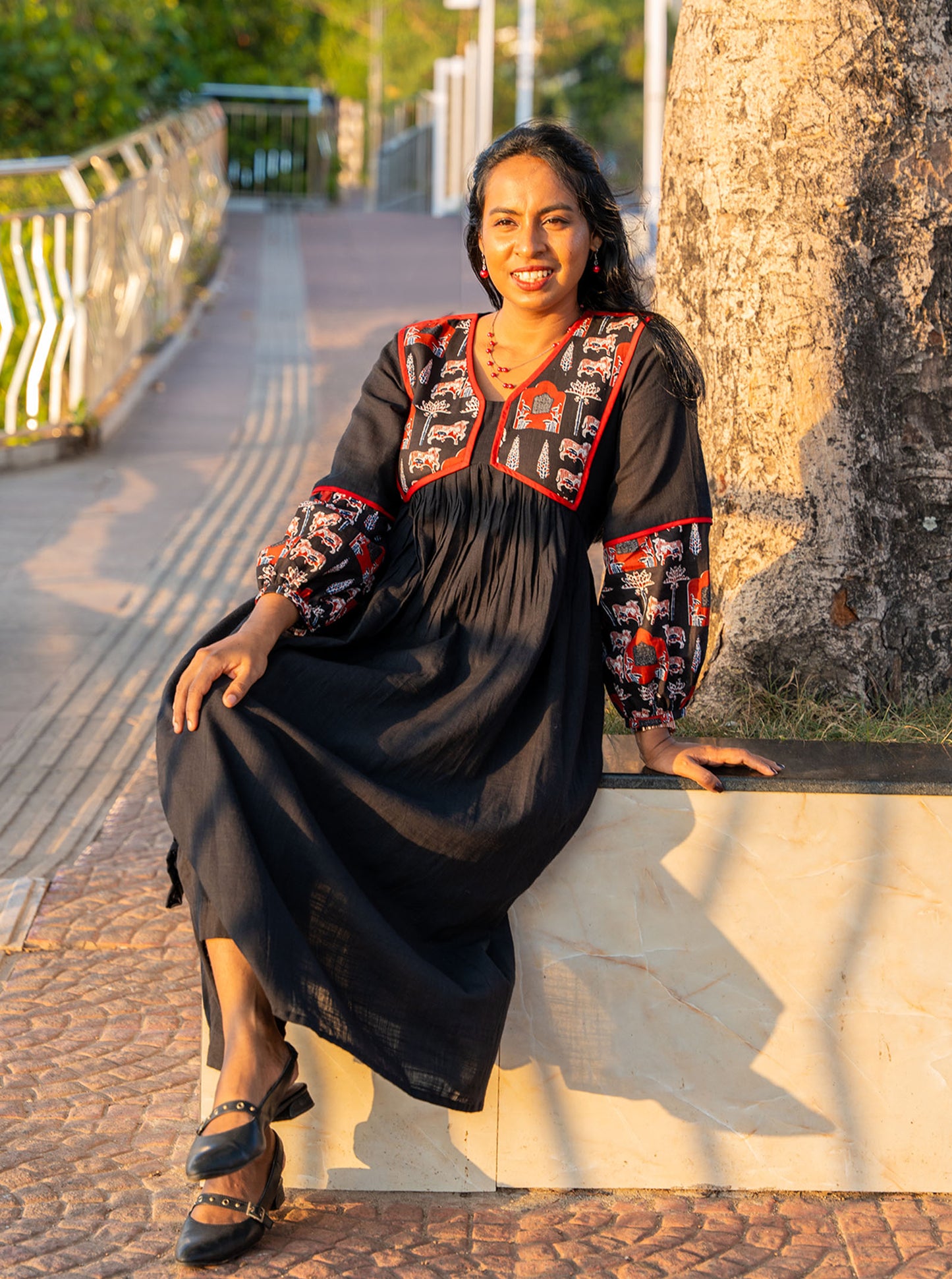 Model wearing black pleated kurti full length — Ariyaa