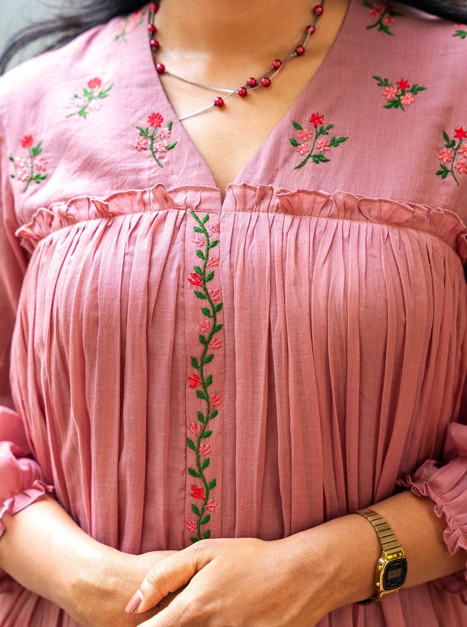 Close-up of machine embroidery detail on pastel pink mul cotton — Ariyaa
