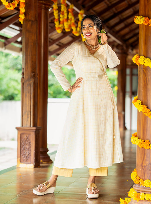 Cream panel cut A-line kurti styled with gold palazzo and wedges - Ariyaa