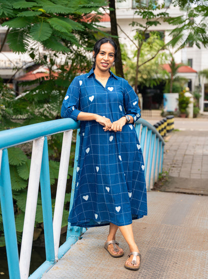 Woman wearing indigo hand block print cotton shirt dress with white heart motifs, front view - Ariyaa
