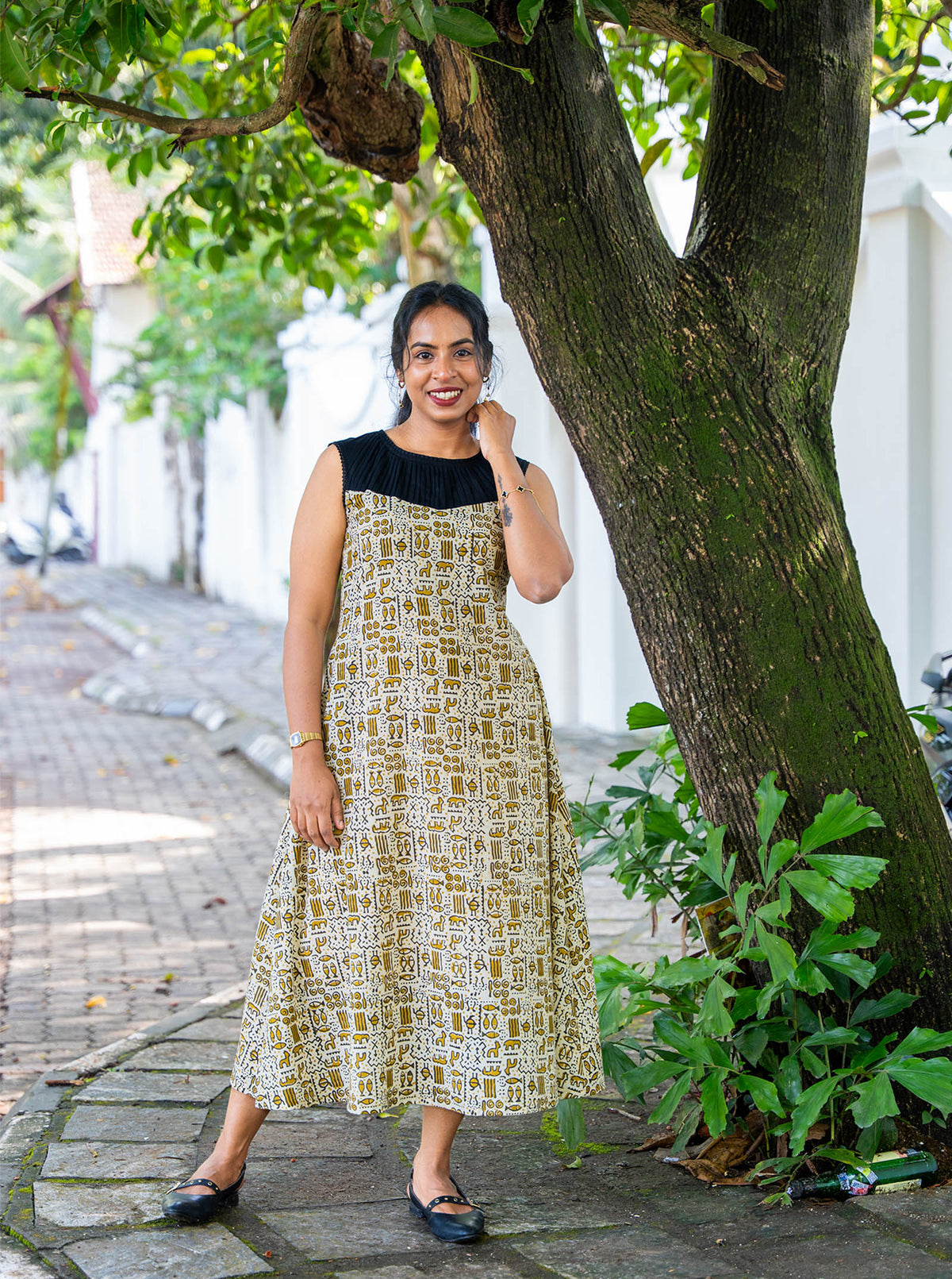 Sandal block print sleeveless A-line kurti with black pleated yoke, full length - Ariyaa