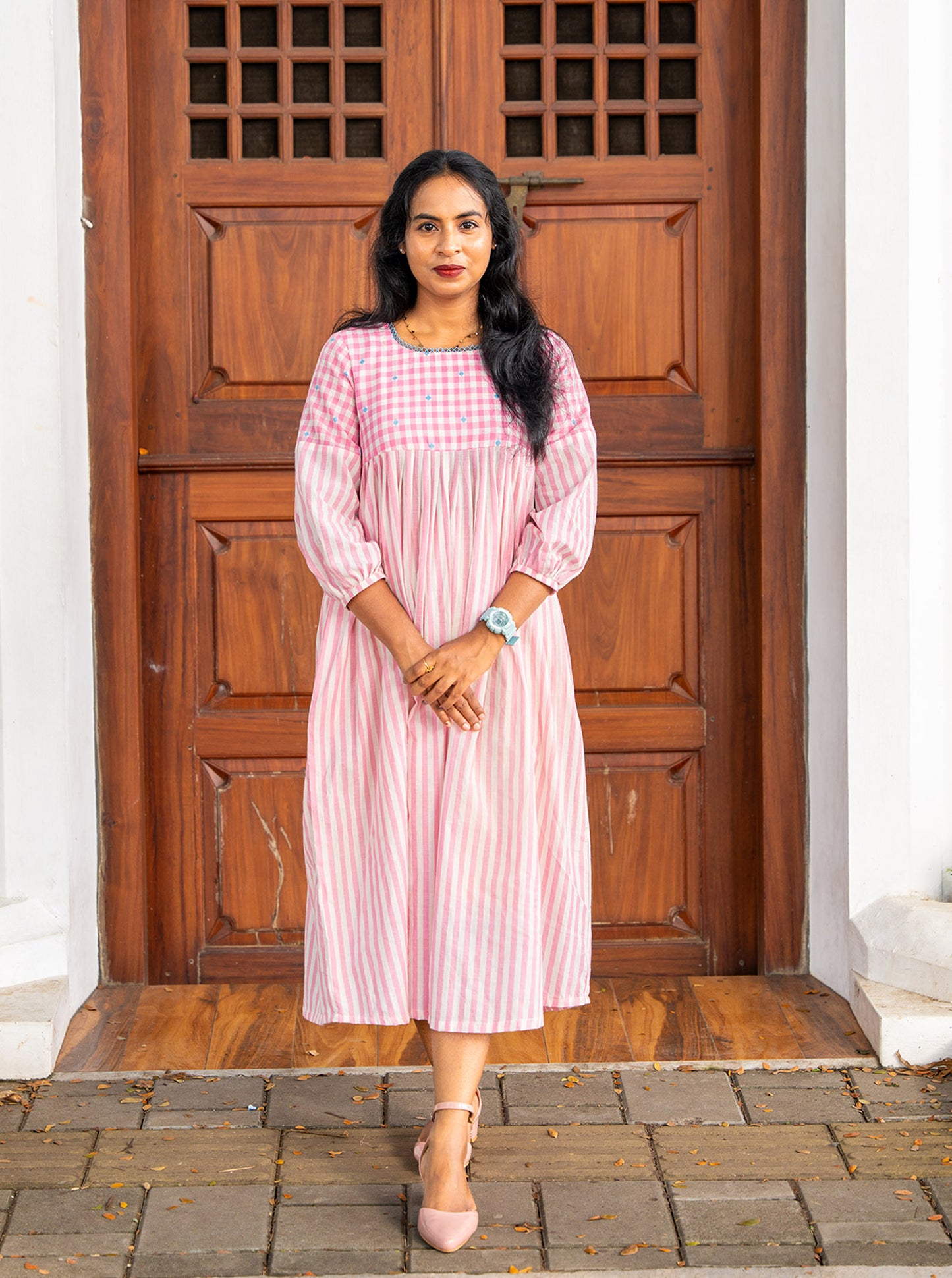 Pink and white handloom cotton A-line pleated kurti front view with checked yoke - Ariyaa