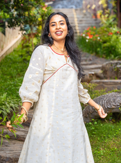 Cream Alia cut cotton kurti with golden butti front view - Ariyaa