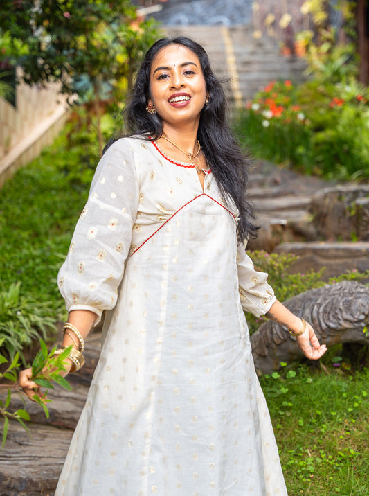Cream Alia cut cotton kurti with golden butti front view - Ariyaa