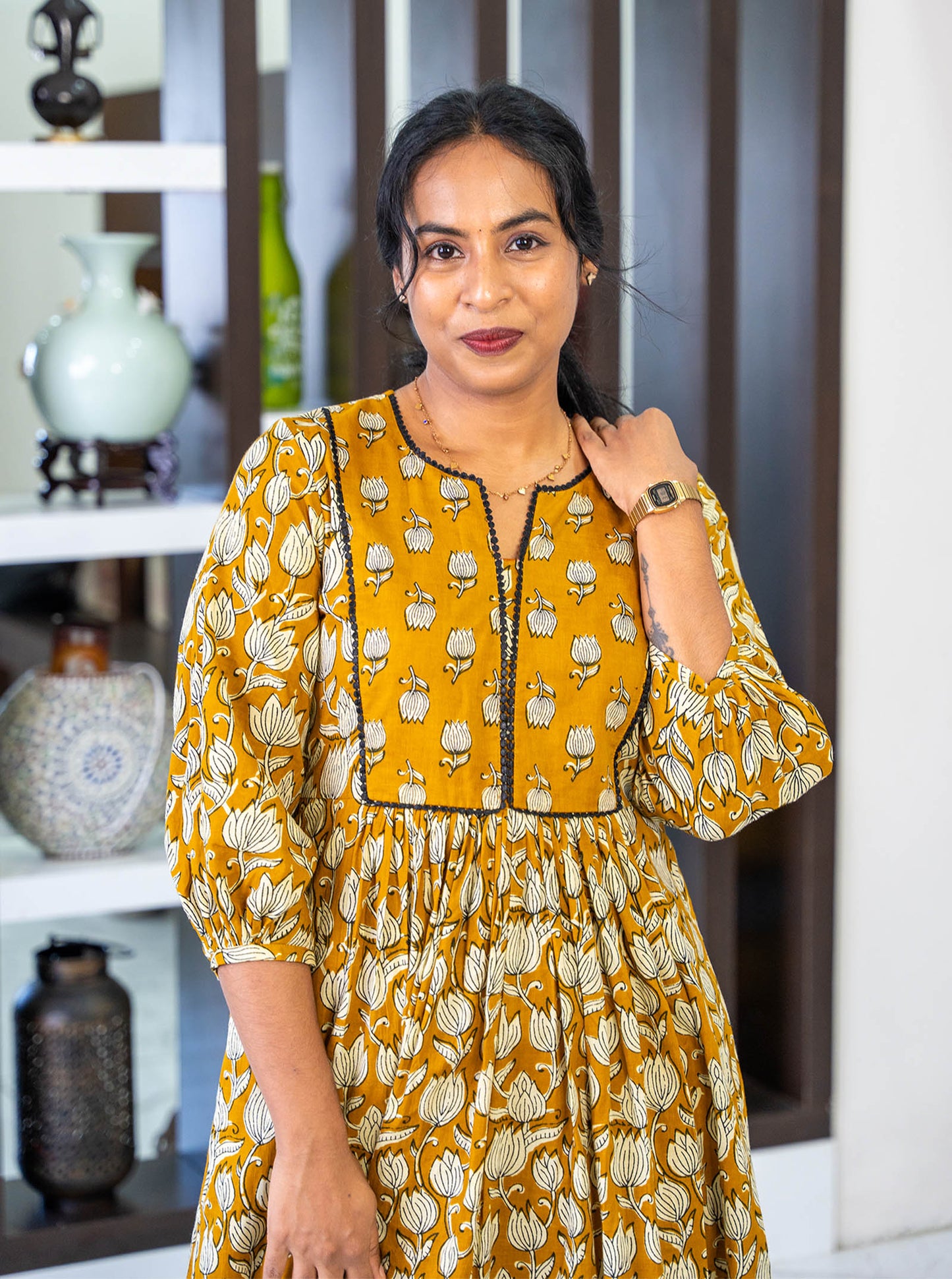 Close-up of tanned yellow floral motif cotton fabric texture - Ariyaa
