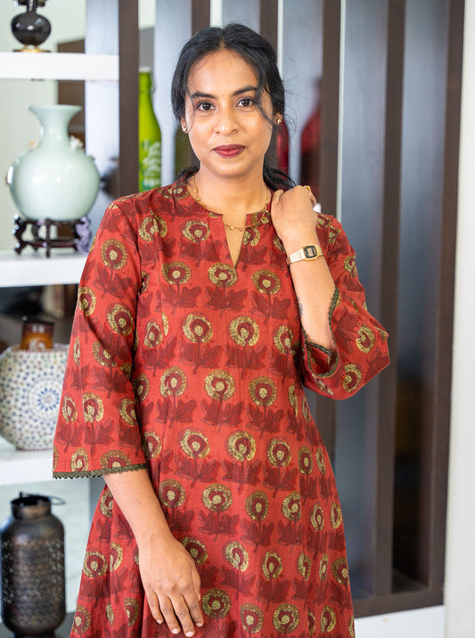 Close-up of dark terracotta floral print cotton fabric texture - Ariyaa