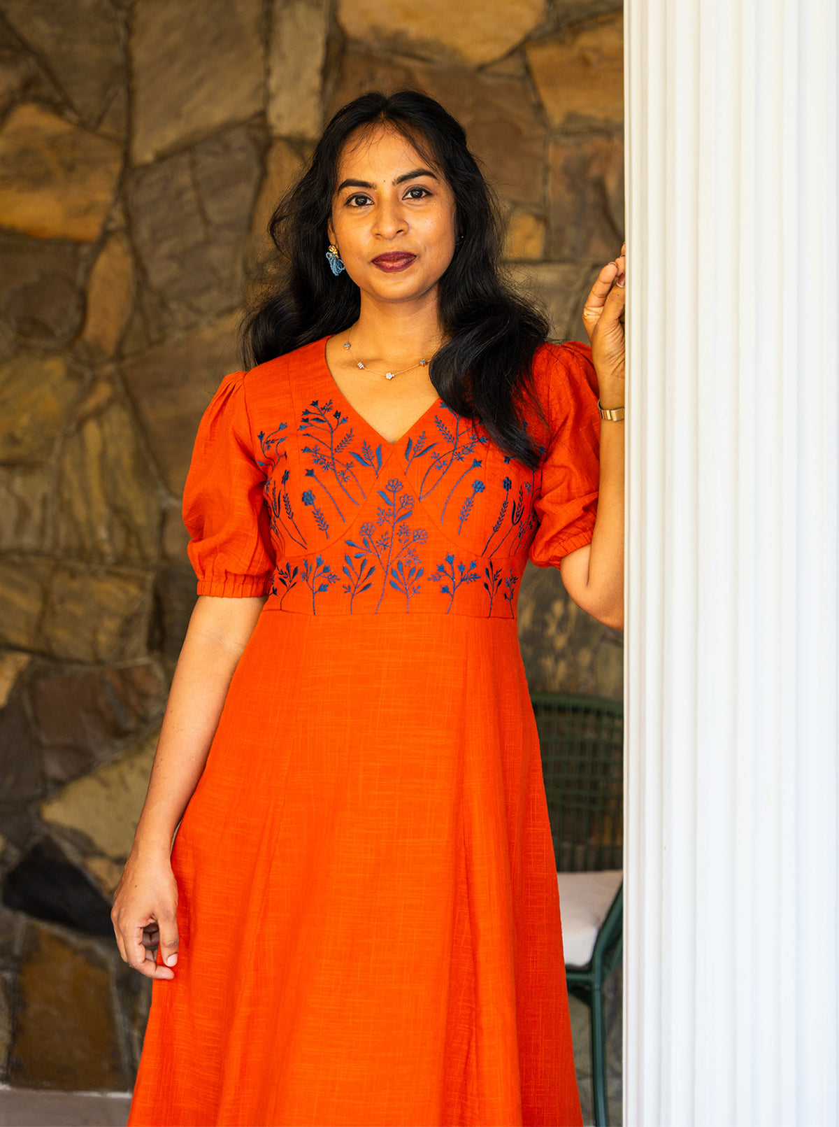 Orange slub cotton dress with puff sleeves and panel cut flare, side front view - Ariyaa