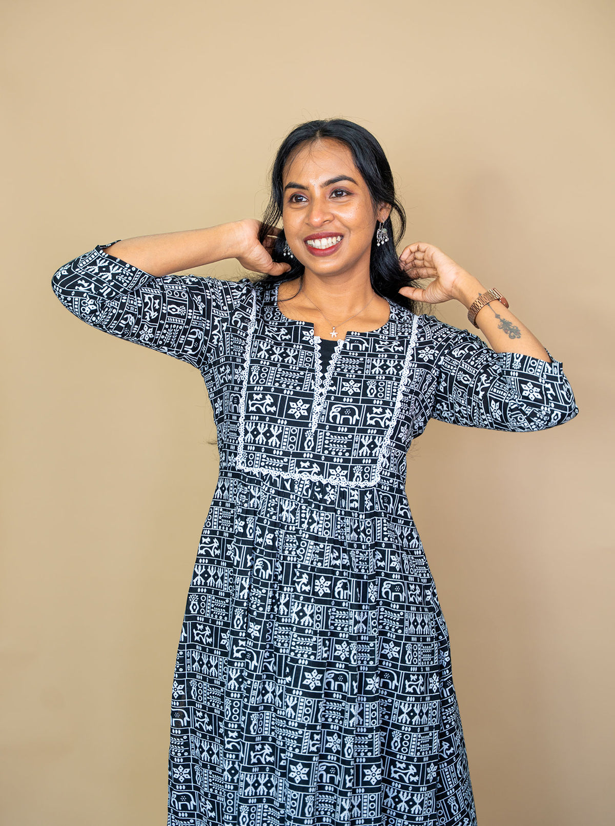 Close-up of white lace trimmed yoke and folk motif print on black cotton kurti - Ariyaa