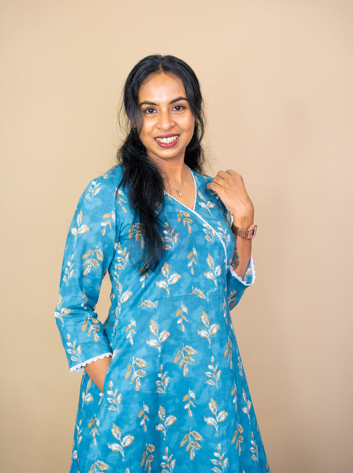 Close-up of tan and white leaf print on soft blue cotton fabric - Ariyaa