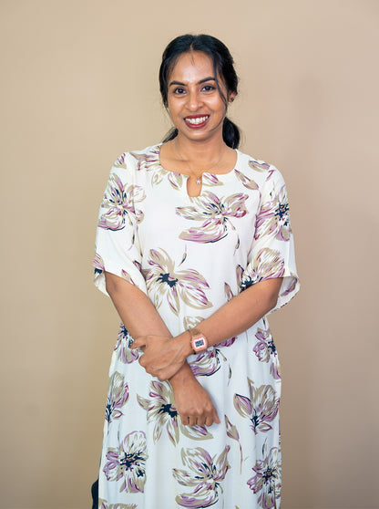 Close-up of round U cut neckline and abstract floral print on cream kurti - Ariyaa