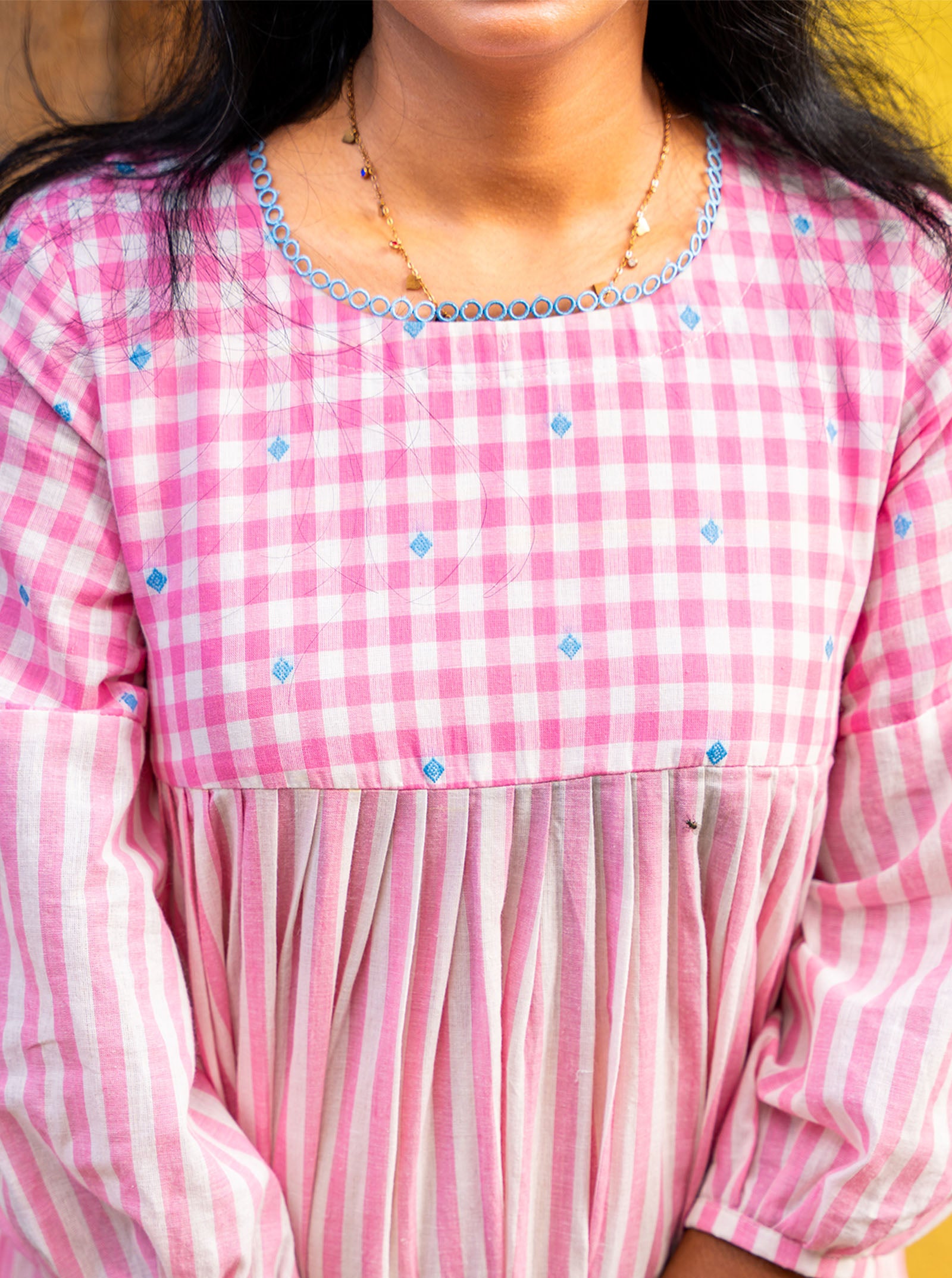 Round neckline with lace detailing on checked yoke close-up - Ariyaa