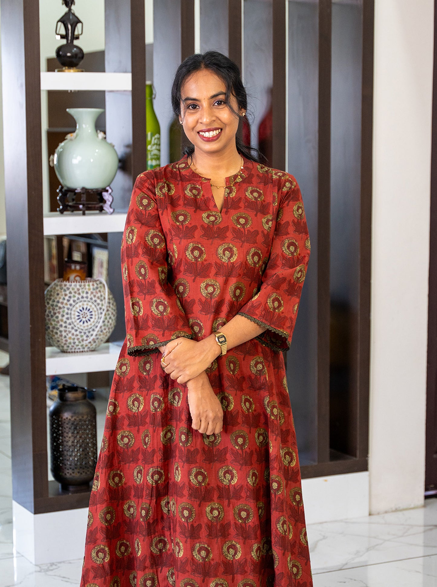 Styled look of terracotta floral cotton kurti for festive and office wear - Ariyaa