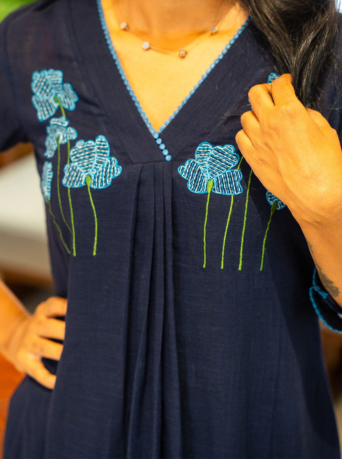Close-up of turquoise and green floral embroidery on navy cotton yoke - Ariyaa