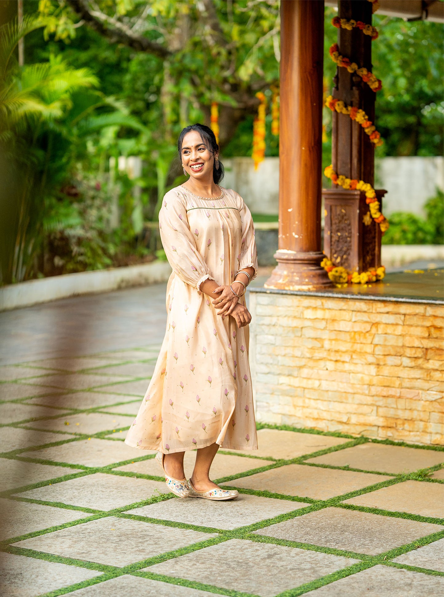 Mythili peach kurti styled with jhumkas, bangles and embroidered juttis for a festive look - Ariyaa