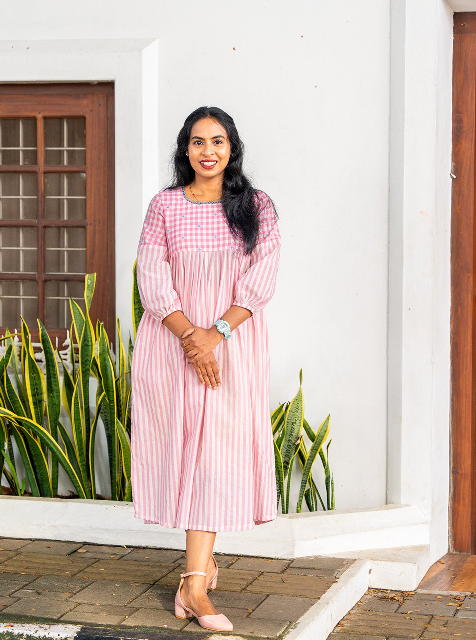 Side profile of A-line pleated cotton kurti showing fit and flare - Ariyaa