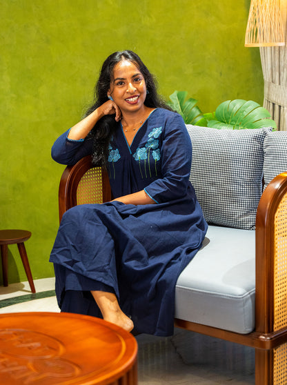 Seated in navy embroidered cotton kurti showing relaxed everyday fit - Ariyaa