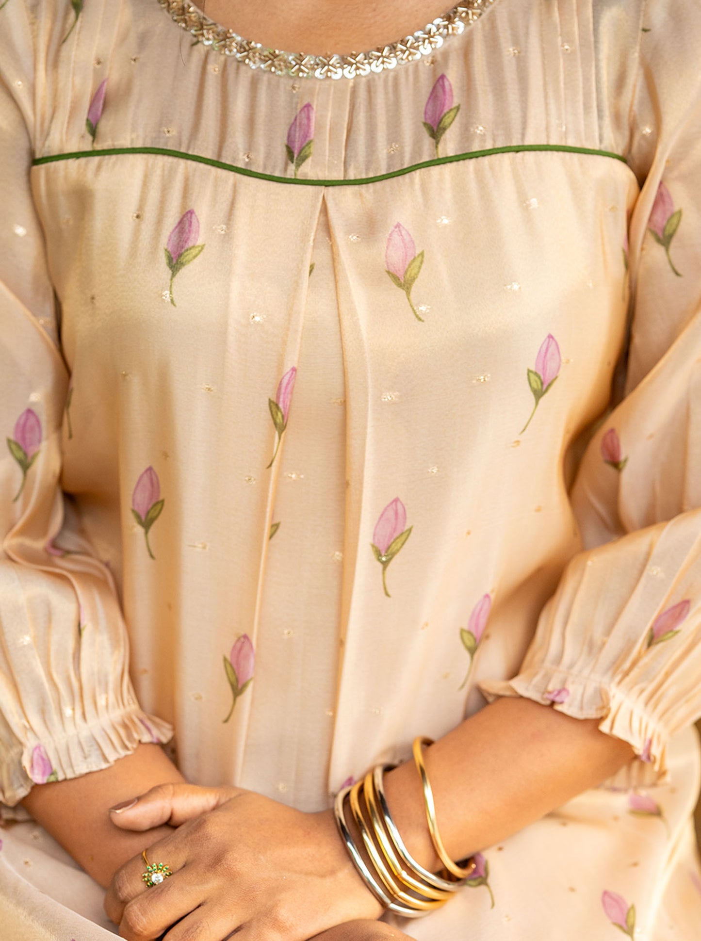 Detail shot of pintuck yoke with green piping and pearl lace round neckline - Ariyaa
