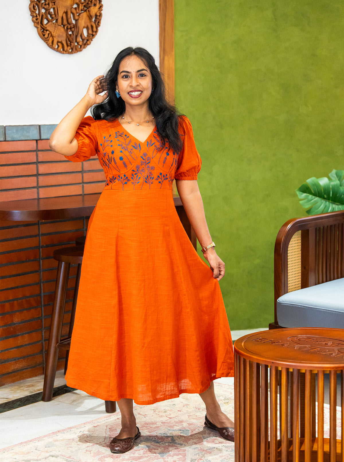 Orange embroidered dress in movement showing A-line swing - Ariyaa