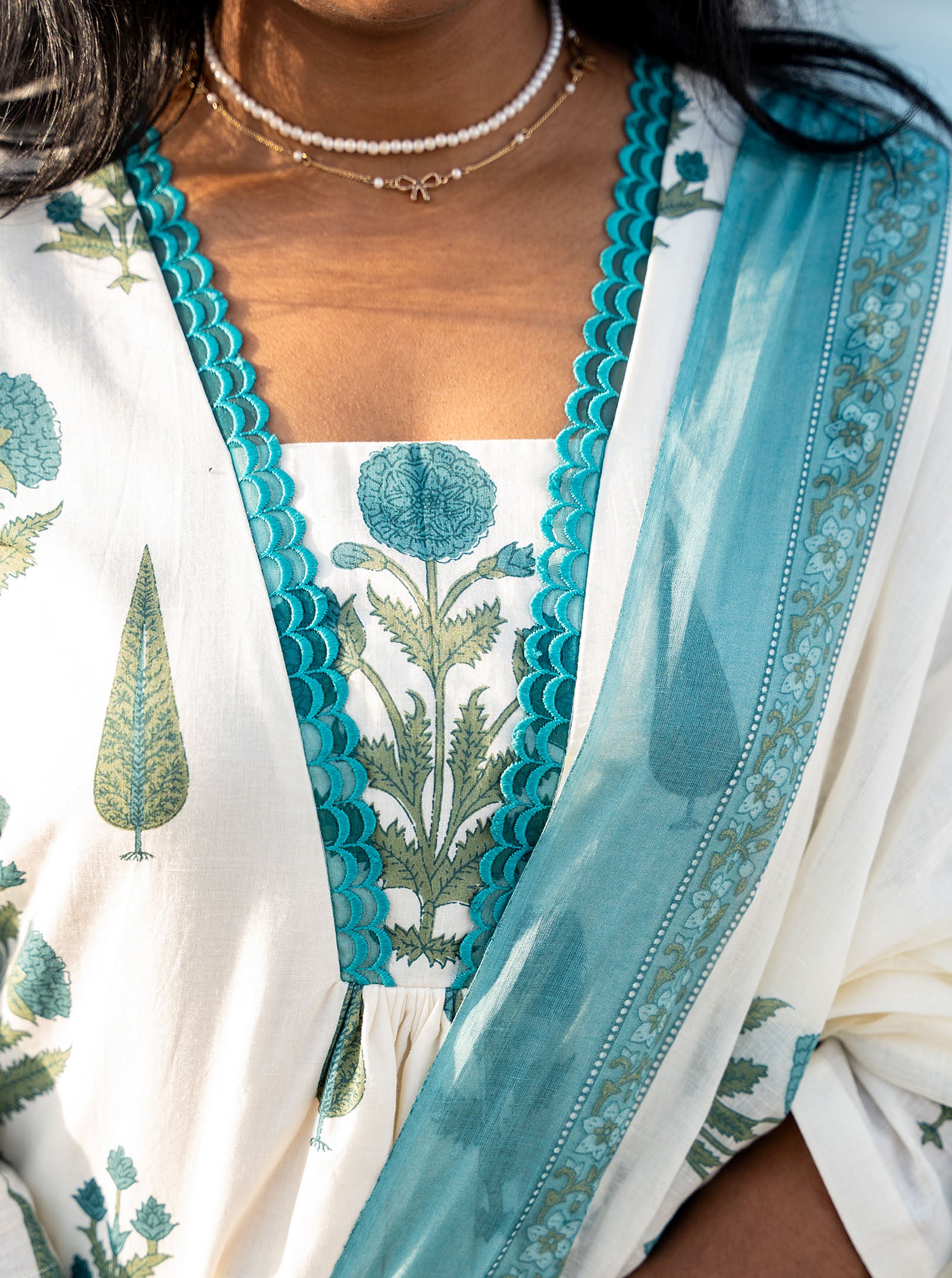 Close-up of cyan floral motif pattern on cotton fabric — Ariyaa