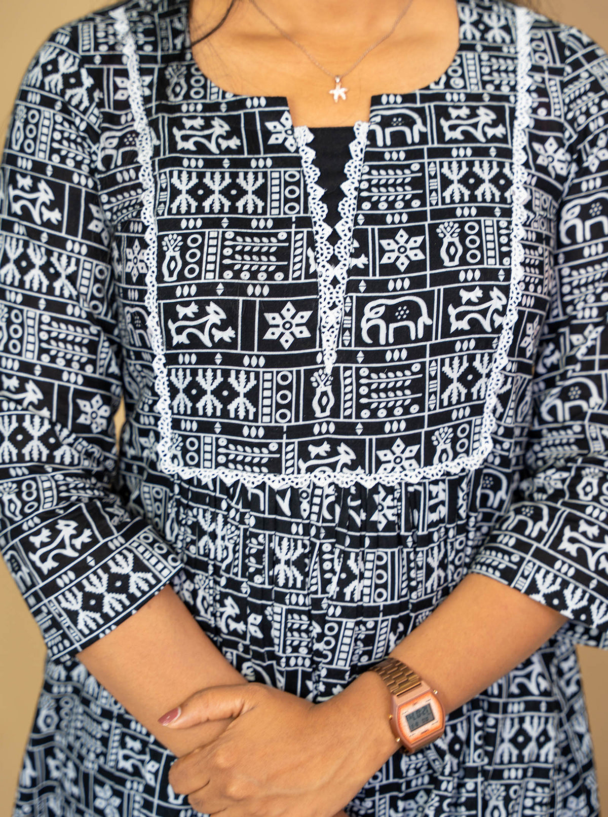 Detail of crochet lace neckline and elephant motif print on black cotton - Ariyaa
