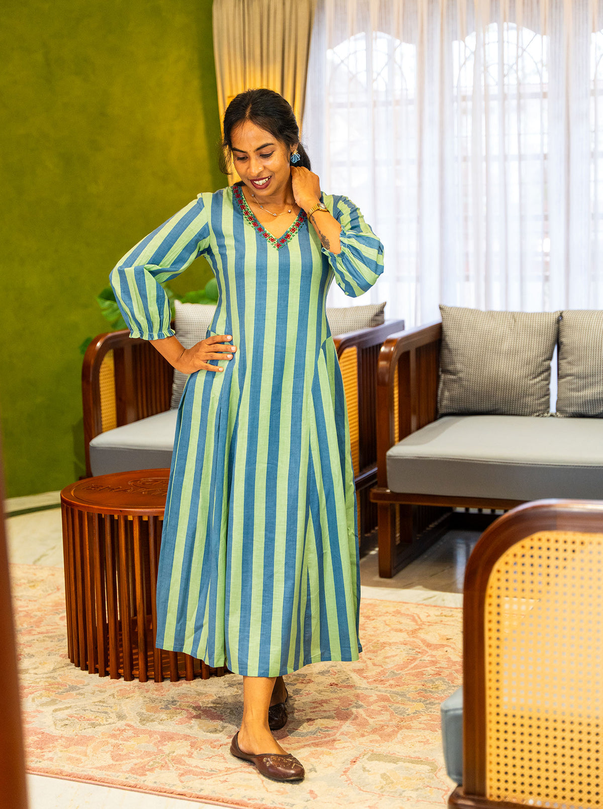 Striped cotton dress in movement showing box pleats and skirt flare - Ariyaa
