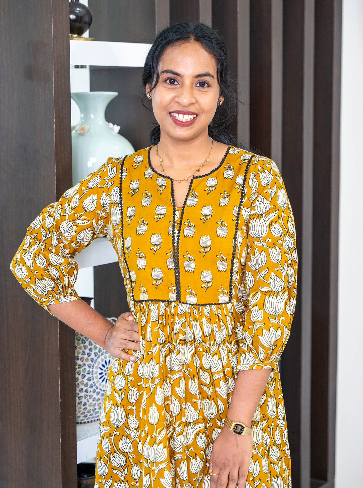 Close-up of tanned yellow floral motif cotton fabric texture - Ariyaa